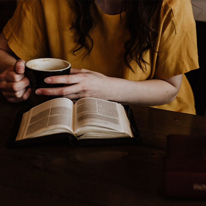 Woman drinking coffee with Bible